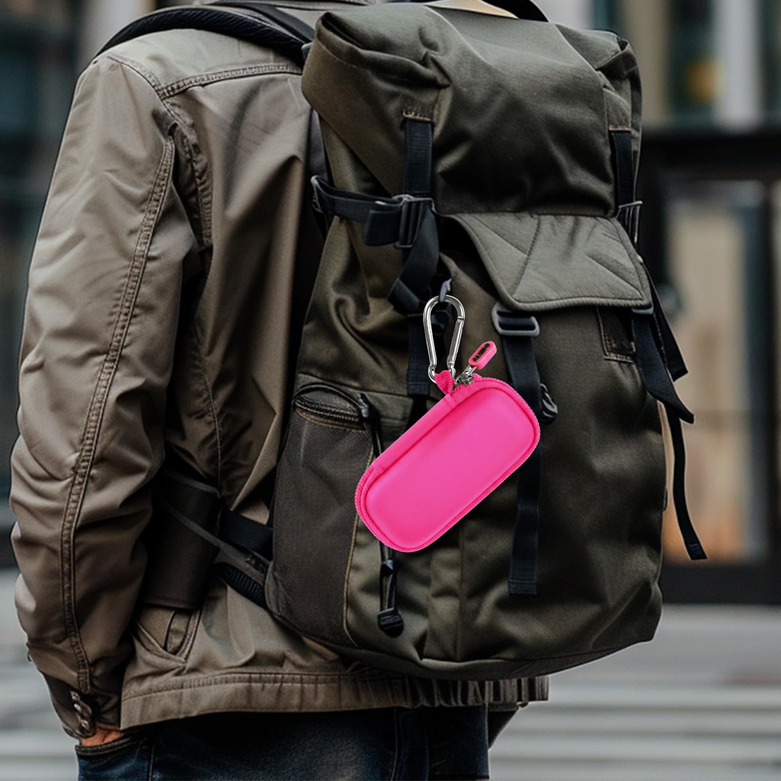 Hot pink USB flash drive and SD card storage case clipped to a backpack