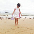 Lavender kids instant print camera case open beside a child using the camera with a parent