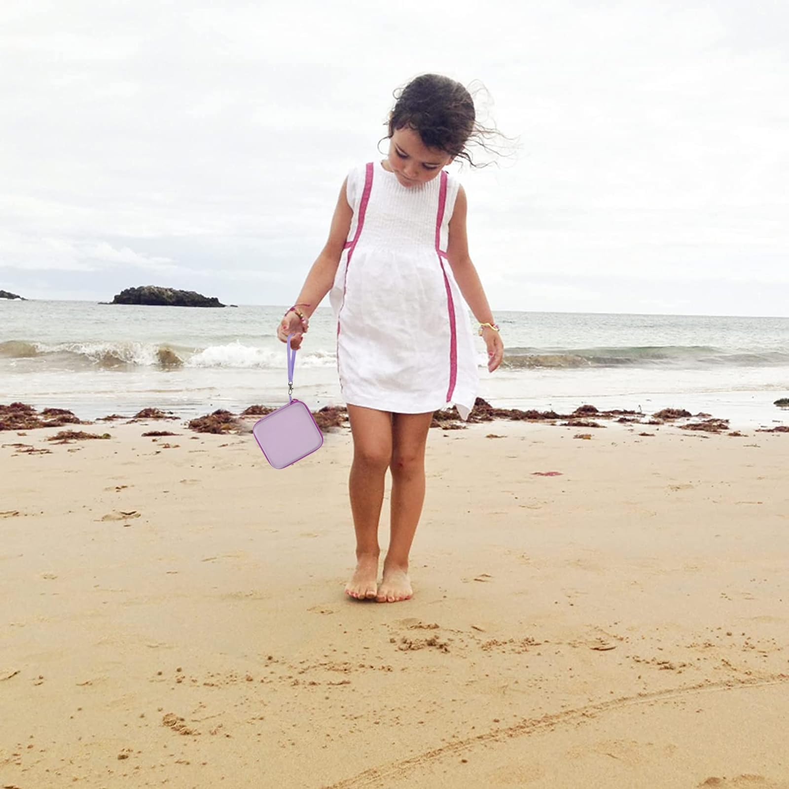 Lavender kids instant print camera case open beside a child using the camera with a parent