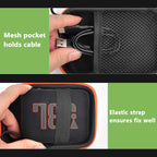 Black and orange speaker case interior with mesh cable pocket and elastic strap holding a JBL Go speaker