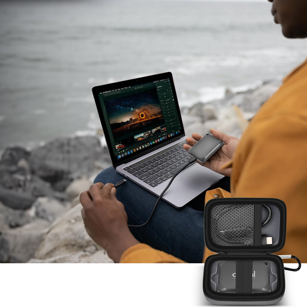 Open gray SSD organizer beside a Crucial portable drive connected to a laptop