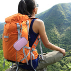 Lavender music player case clipped to a hiking backpack