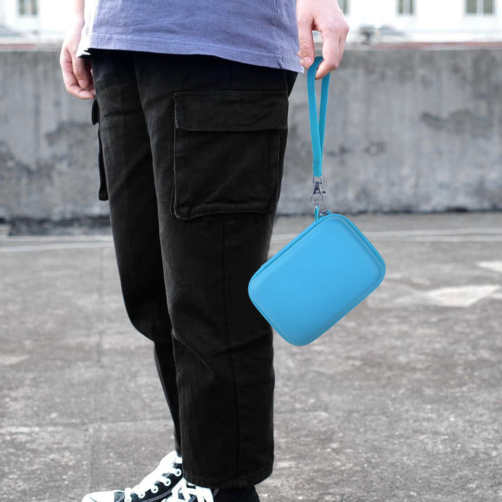 Light blue retro handheld console carrying case carried by the wrist strap outdoors