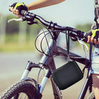 Black camera case attached to a bicycle handlebar