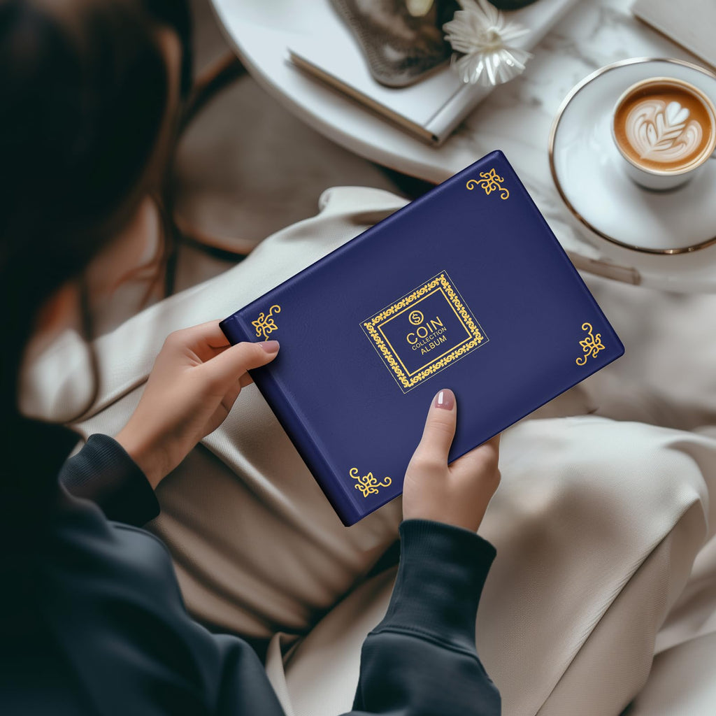 Person holding the closed navy coin collection album