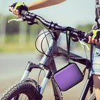 Purple camera case attached to a bicycle handlebar