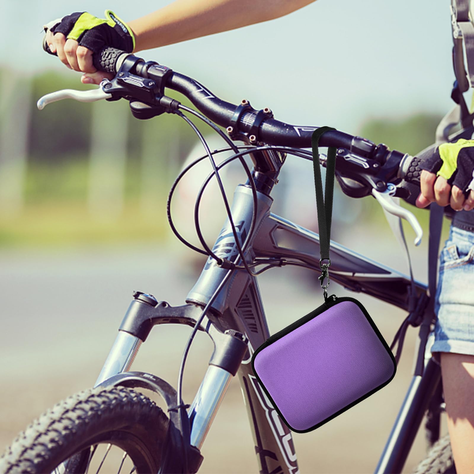 Purple camera case attached to a bicycle handlebar