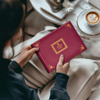 Person holding the closed burgundy coin collection album