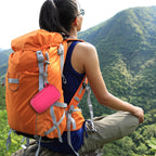 Pink music player case clipped to a hiking backpack