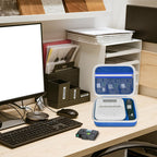 Open blue and white label maker case organizing a printer and tapes on an office desk