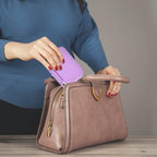 Woman packing the purple mini printer case into a handbag