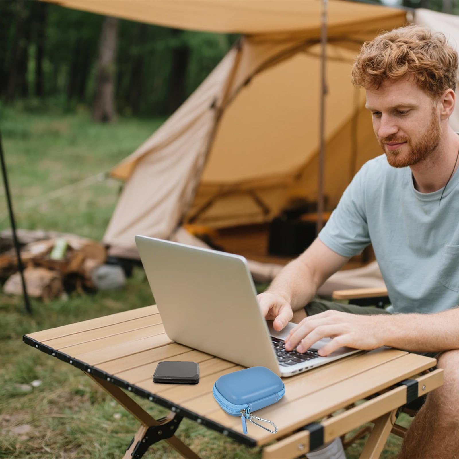 Blue SSD case beside a portable drive during outdoor laptop use
