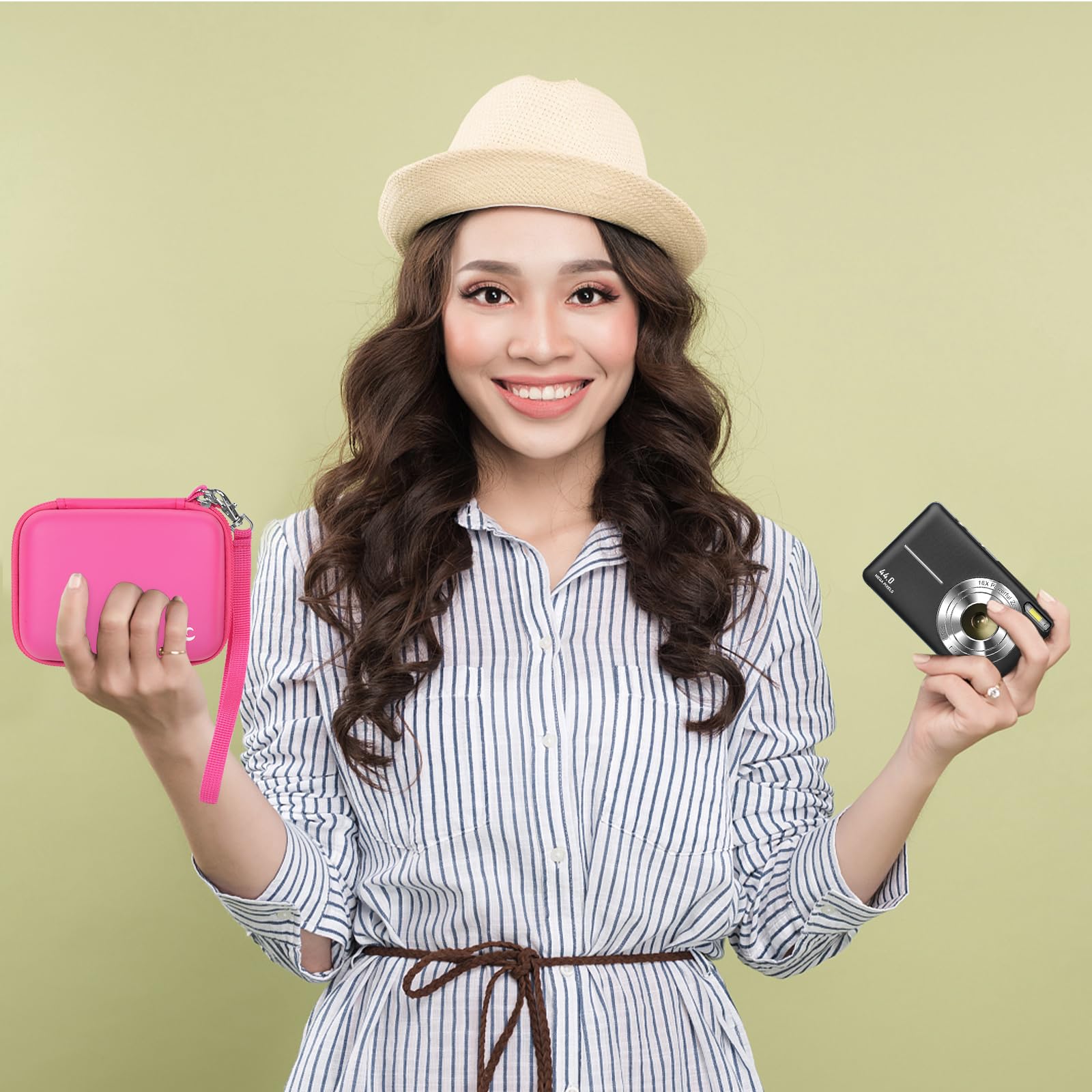 Woman holding the bright pink camera case beside a compact digital camera
