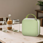 Closed light green NIIMBOT label maker case beside bottles and jars