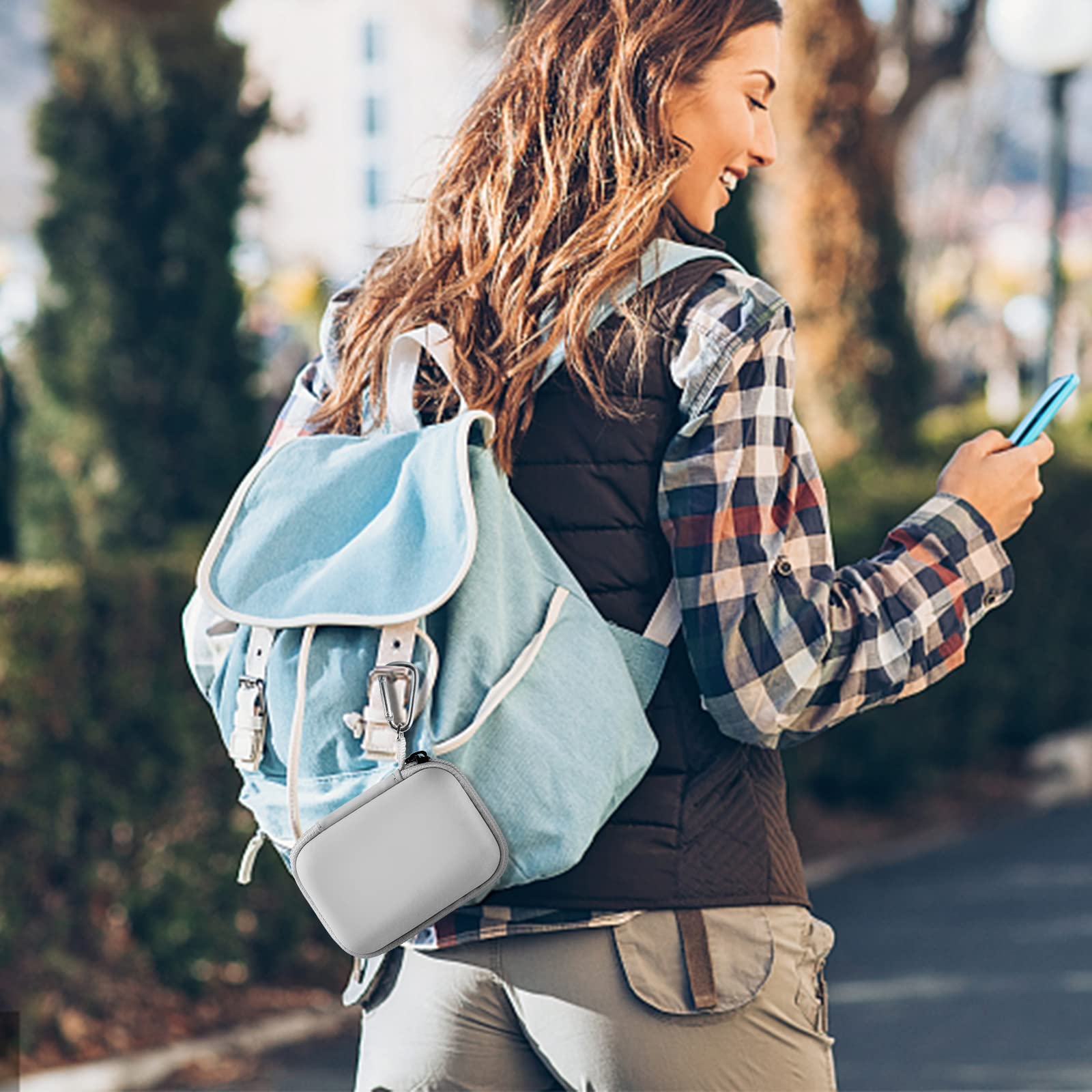 Gray mini power bank case attached to a backpack for travel