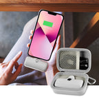 Open gray case organizing a mini power bank and cable beside a charging phone