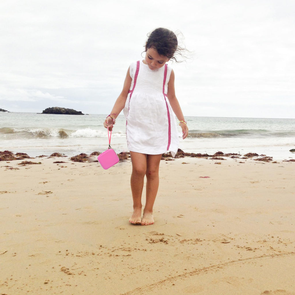 Pink kids instant print camera case carried by a child outdoors