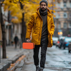 Person carrying the orange dual microphone case by its top handle