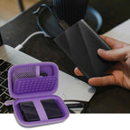 Purple portable SSD case organizing an external drive beside a laptop