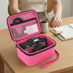 Open hot pink camera case organizing a camera and accessories on a desk
