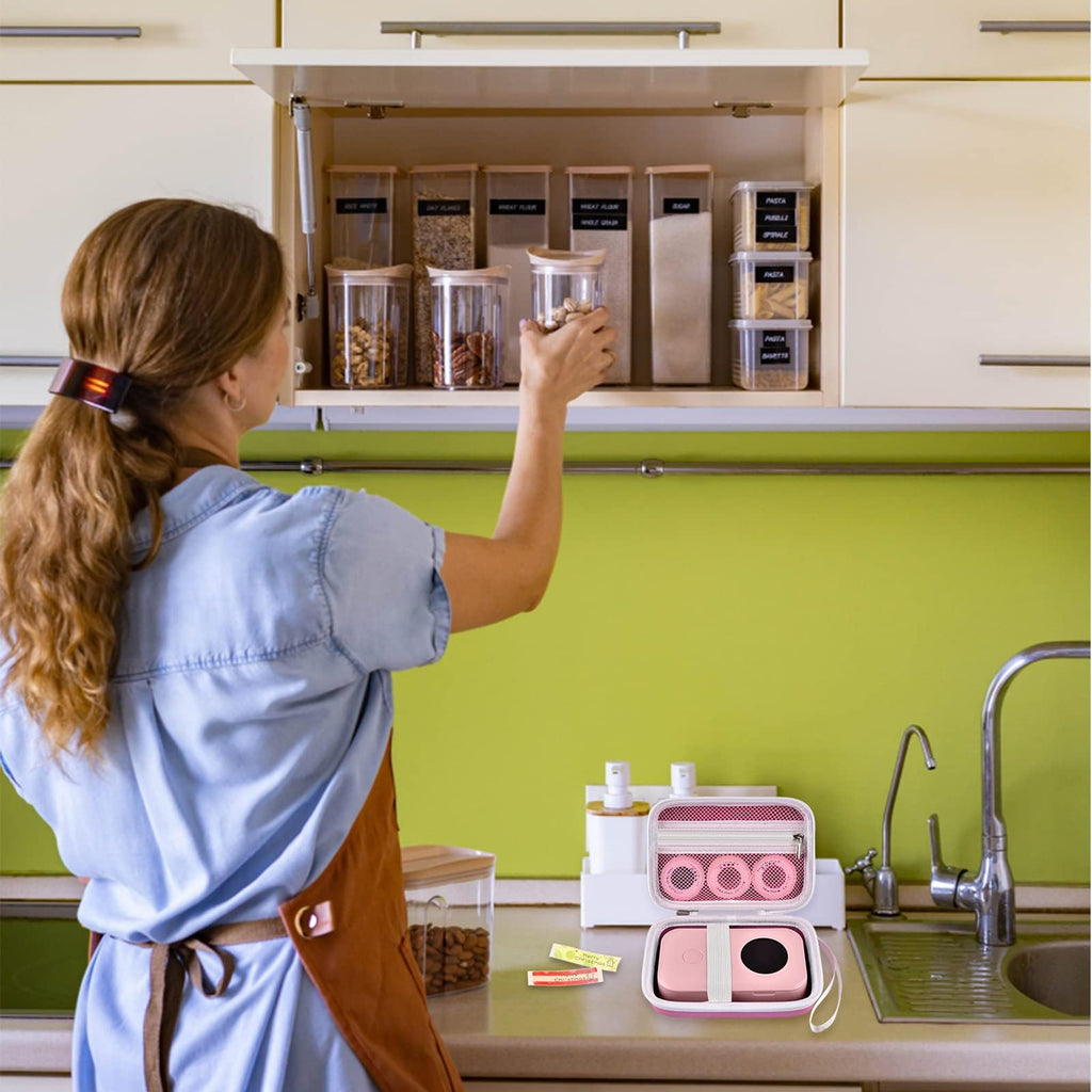 Pink label maker case beside a mini printer in a kitchen organization scene