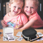 Children using a mini label printer beside the black carrying case