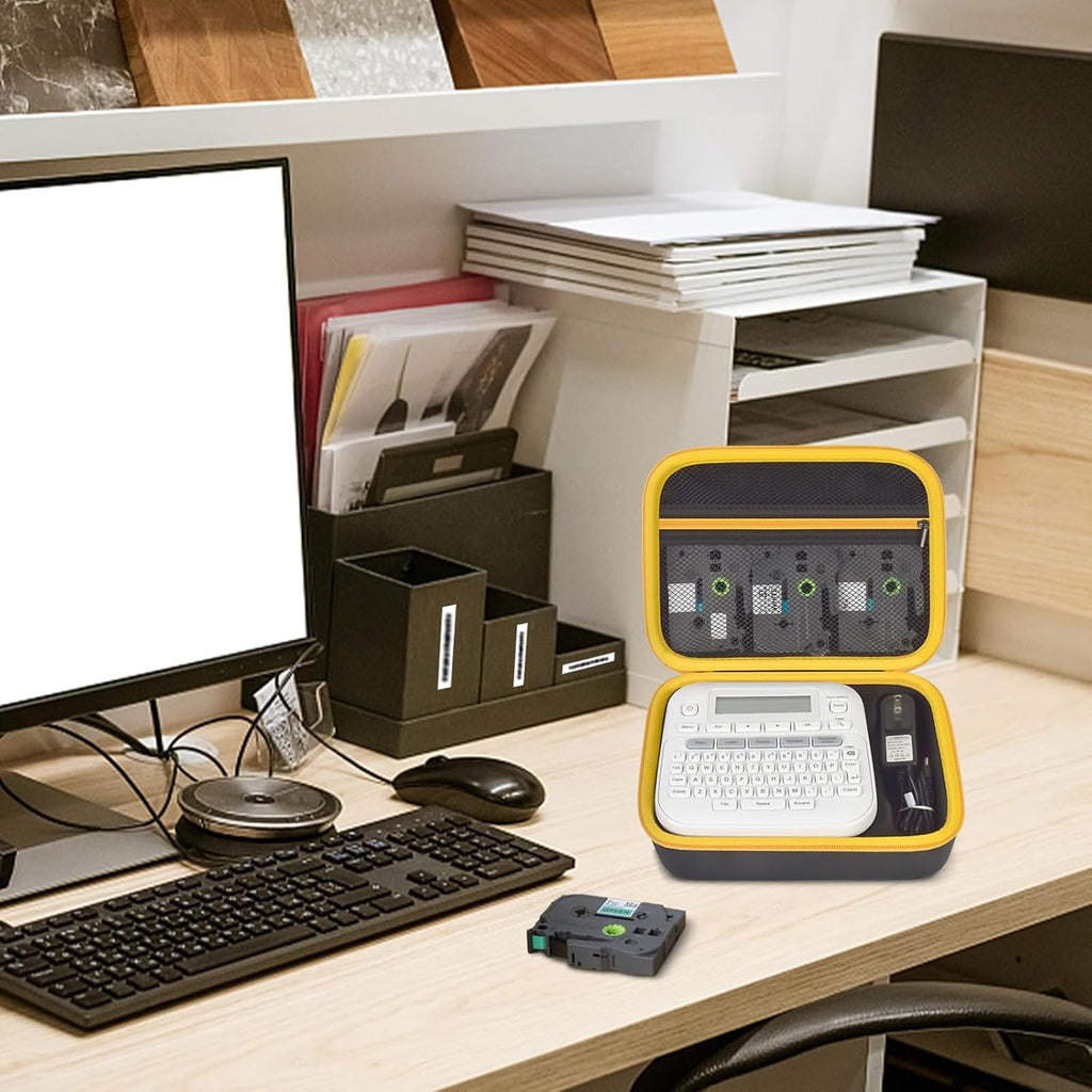 Open black and yellow label maker case organizing a printer and tapes on an office desk