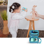 Teal protective digital camera case shown beside a child using a compact camera
