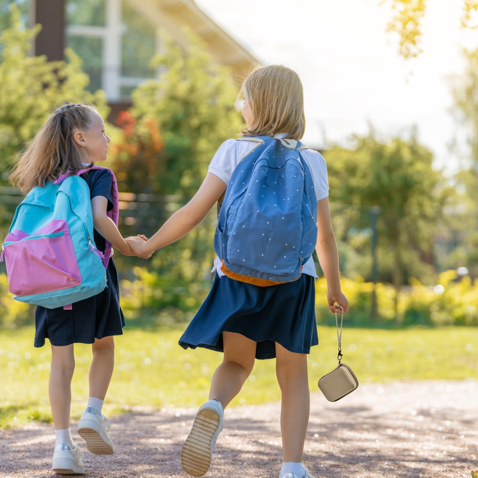 Khaki protective digital camera case shown carried by children on an outdoor walk