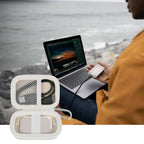 Open ivory SSD organizer beside a Crucial portable drive connected to a laptop
