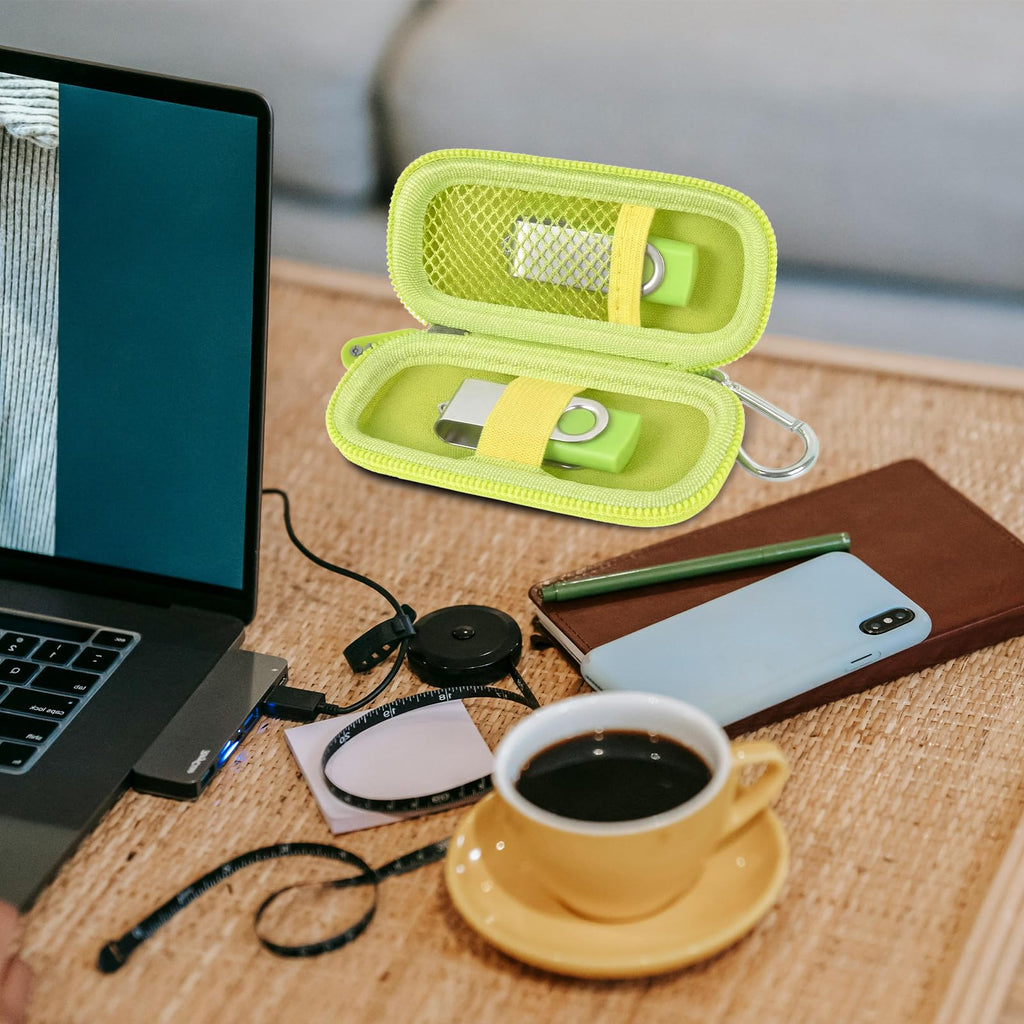 Neon green USB flash drive and SD card storage case open on a desk with electronics accessories