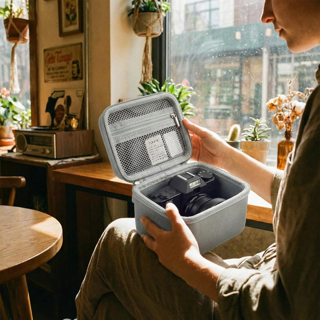 Traveler handling the open gray camera organizer at a cafe