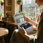 Traveler handling the open gray camera organizer at a cafe