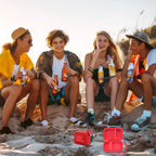 Friends using a JBL Go speaker with the open red travel case at the beach