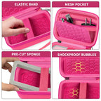 Bright pink camera case interior with elastic strap, mesh pocket, foam insert, and shock-absorbing padding