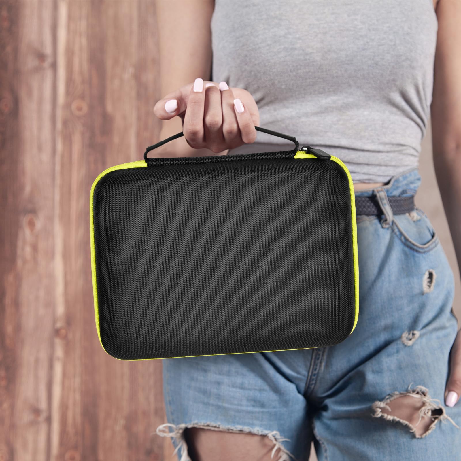 Person carrying the black and neon yellow label maker case by its handle