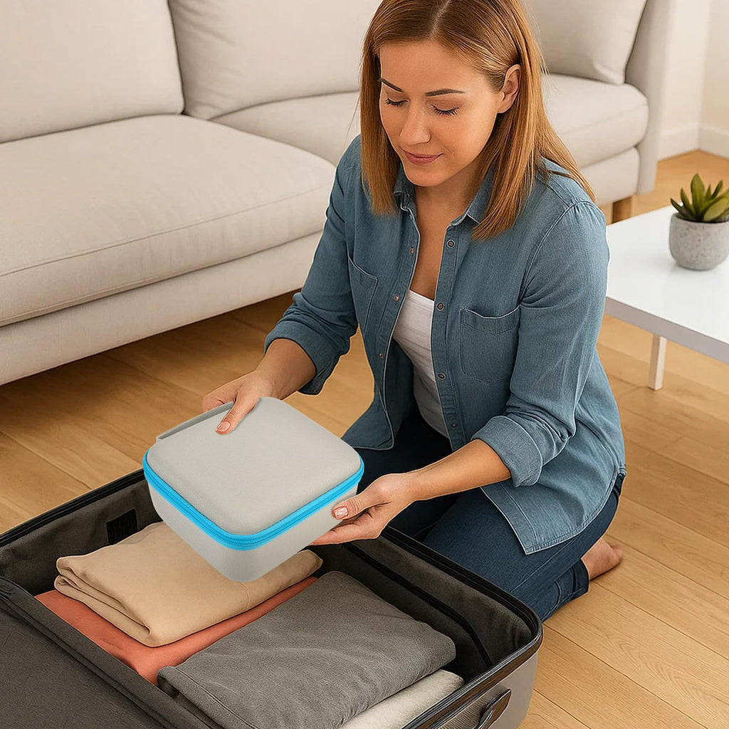 Gray and blue label maker carrying case being packed into a suitcase