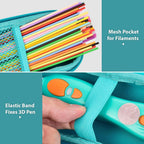 Teal case interior with mesh filament pocket and elastic strap securing the 3D pen