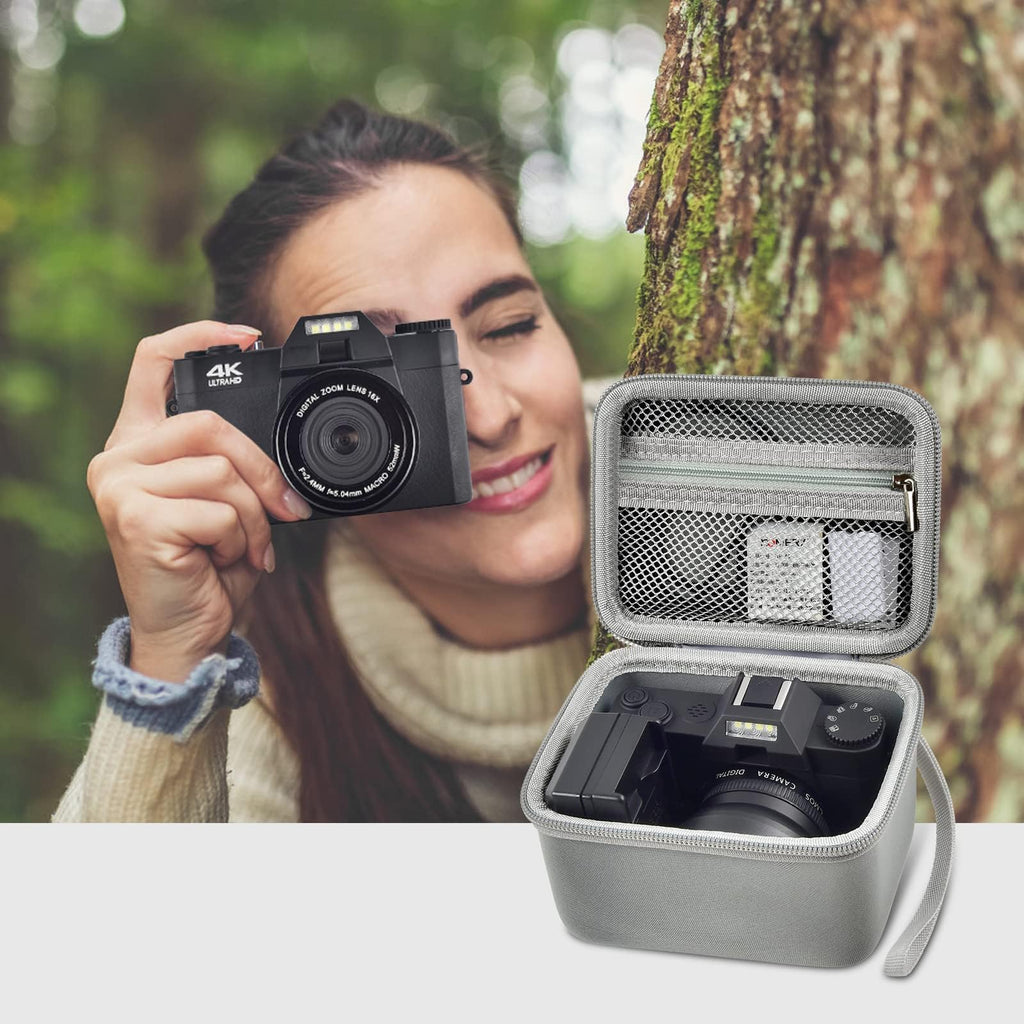 Photographer using a compact camera beside the open gray organizer