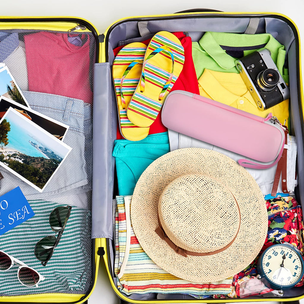 Pink electric toothbrush case packed inside a suitcase