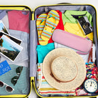 Pink electric toothbrush case packed inside a suitcase