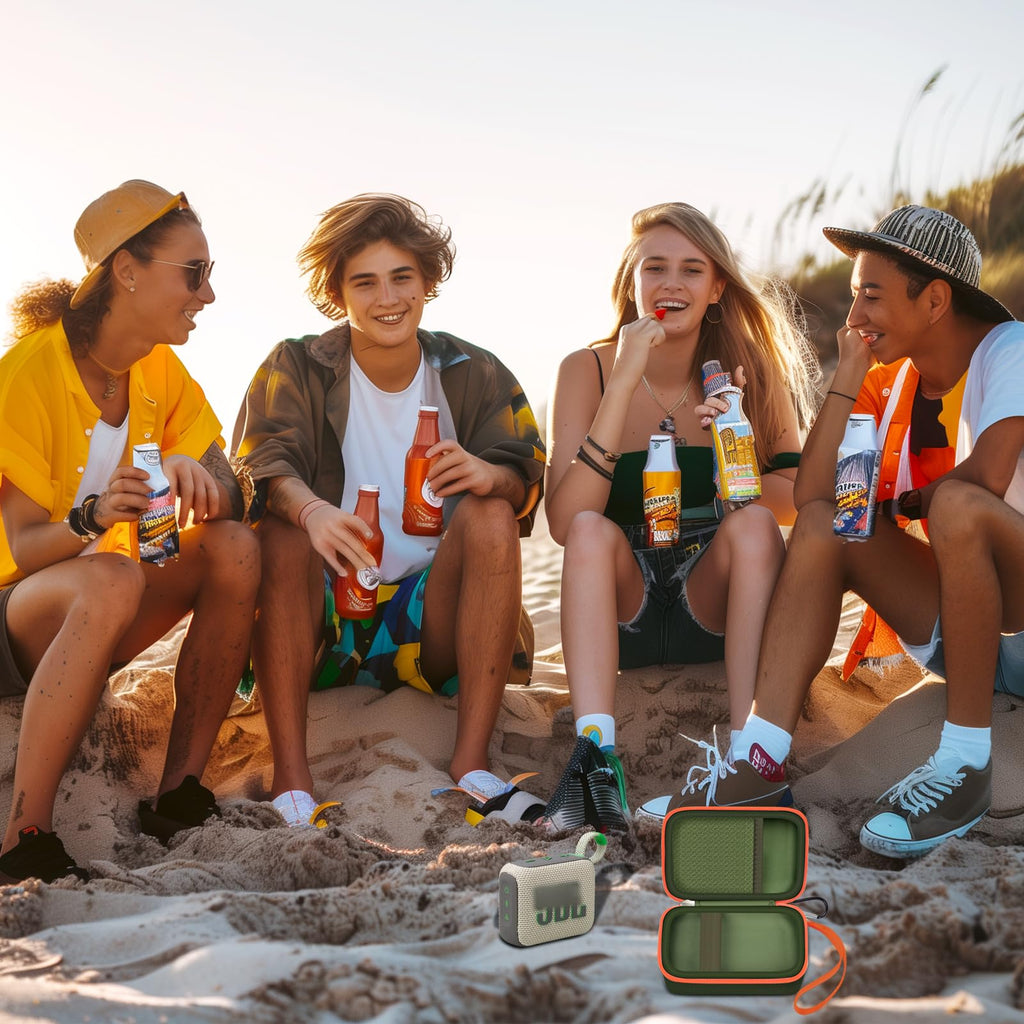Friends using a JBL Go speaker with the open dark green and orange travel case at the beach