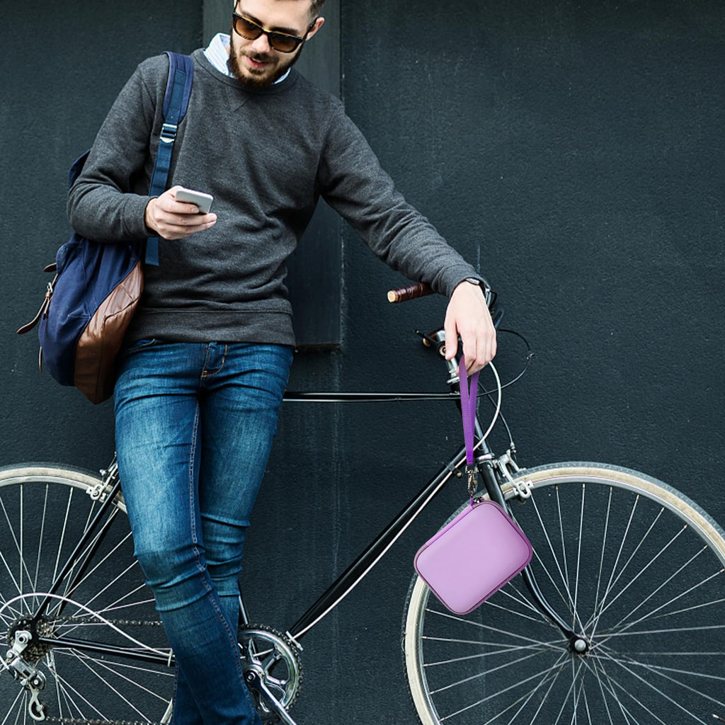 Person carrying the lavender power bank case beside a bicycle