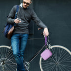 Person carrying the lavender power bank case beside a bicycle