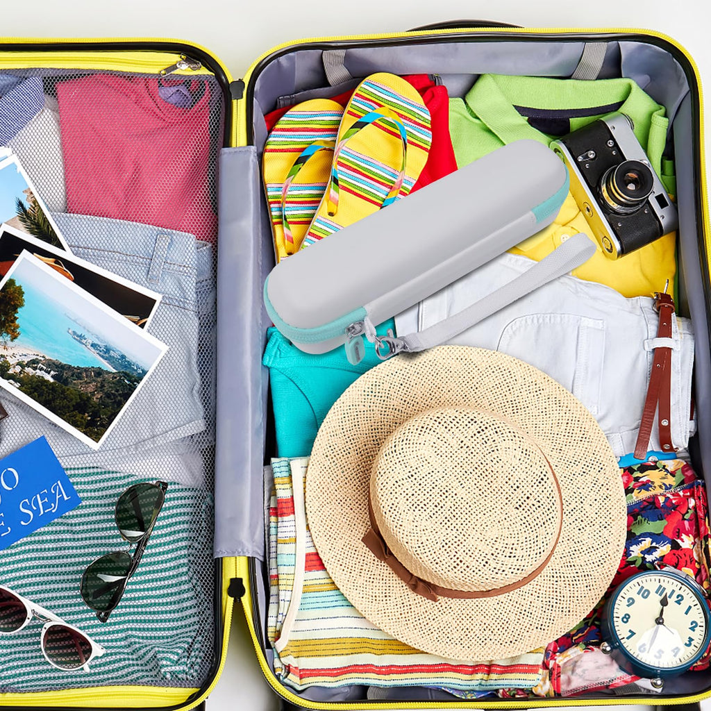White and teal electric toothbrush case packed inside a suitcase