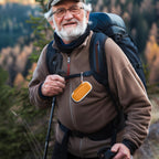 Hiker carrying the orange KardiaMobile case on a backpack strap