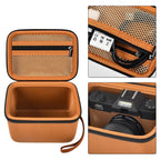 Orange camera organizer interior with mesh accessory pocket and padded divider