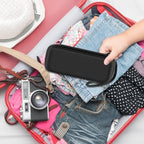 Black electric toothbrush case packed inside a suitcase