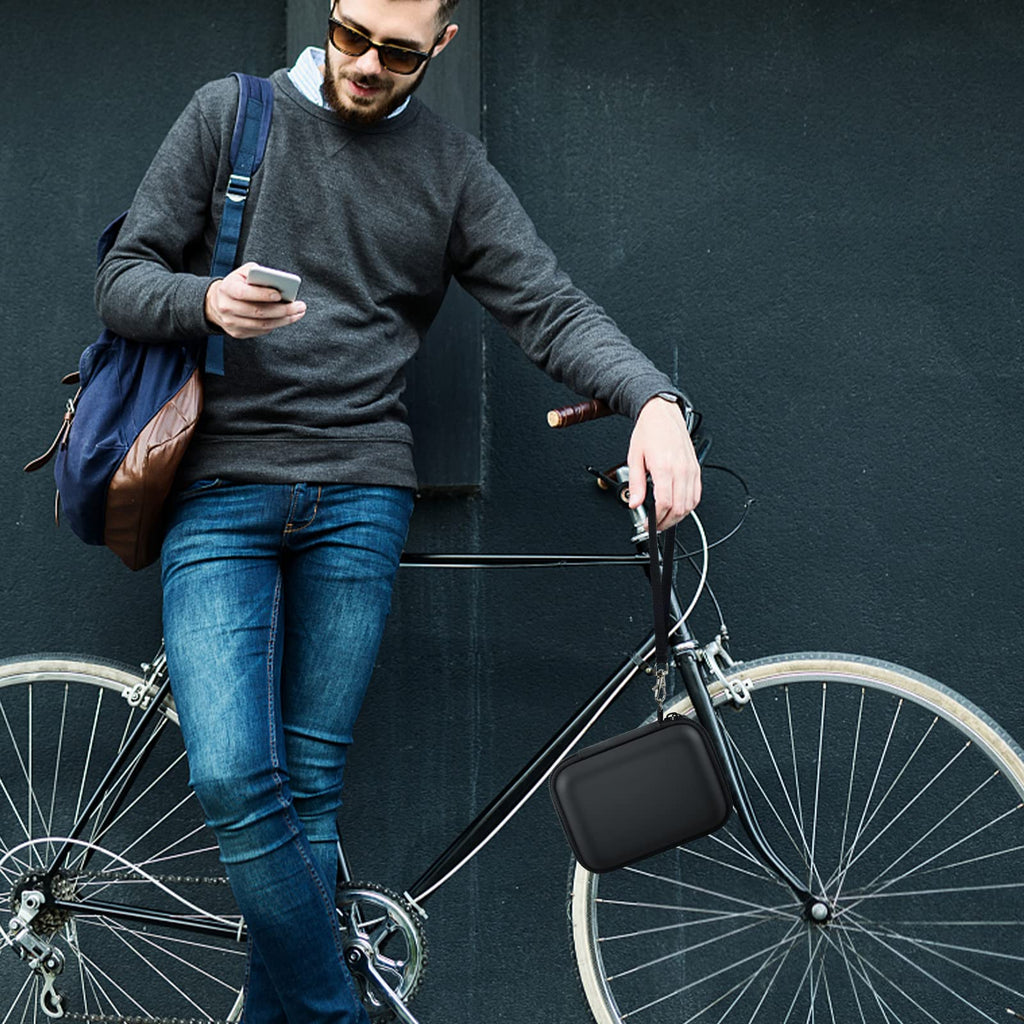 Person carrying the black power bank case beside a bicycle