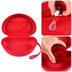 Open red headphone case with mesh accessory pocket and folded over-ear headphones